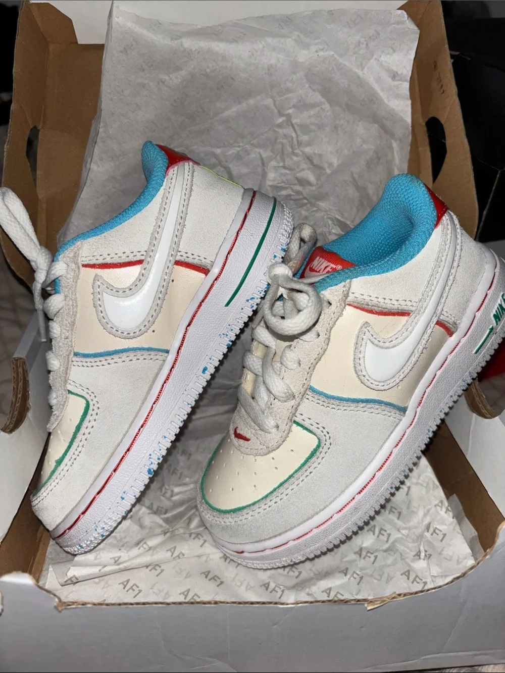 Nike Kids White Sneakers with Blue, Red & Green Accents